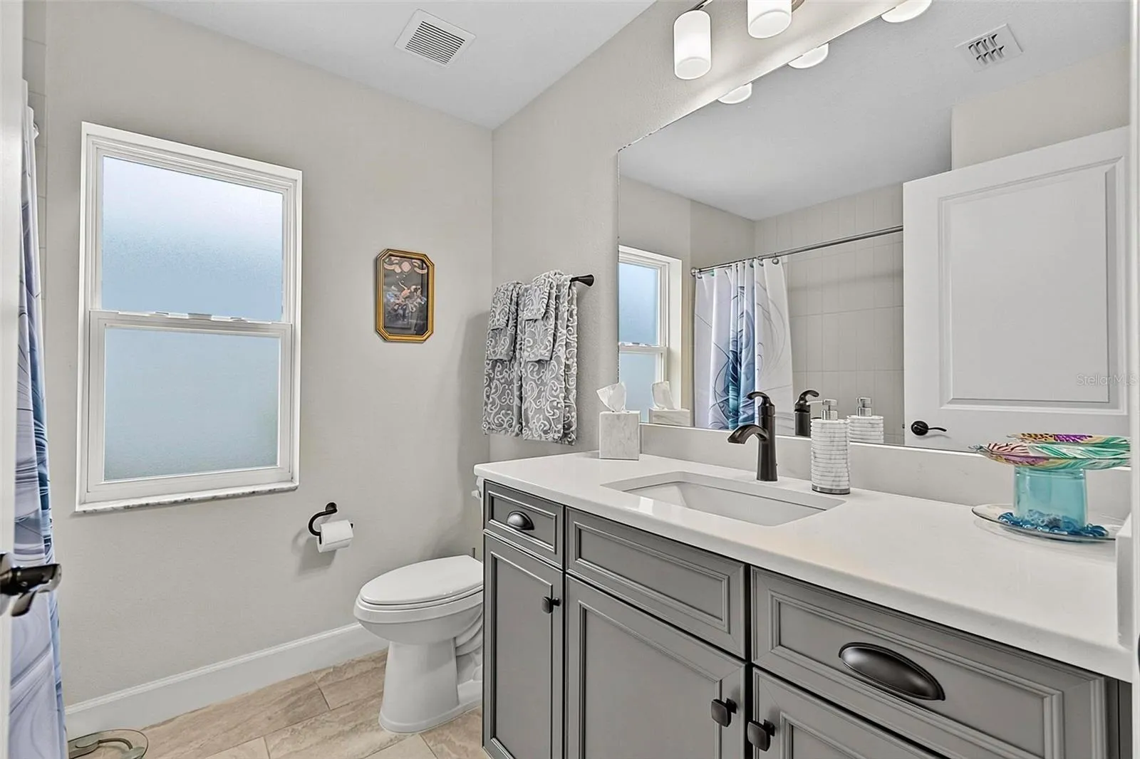 Guest bathroom with upgraded cabinets and black matte hardware