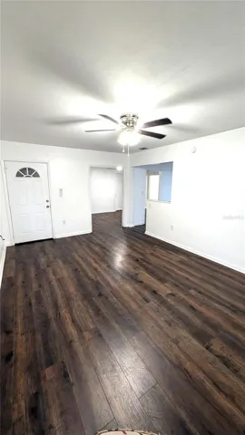 Living Room with Front Door and doorway to Dining Room and Kitchen to the right