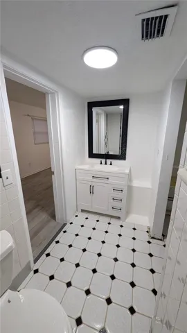 Master Bathroom Vanity and door to bedroom on left, walk in closet on right