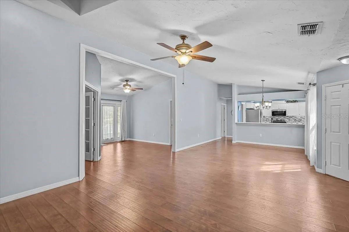 Living Room, Dining Room, Kitchen, Den with Double French Doors, Open Bonus Room to Exterior French Doors to Back Patio and Pond.