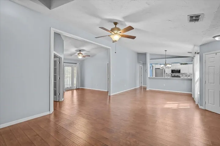 Living Room, Dining Room, Kitchen, Den with Double French Doors, Open Bonus Room to Exterior French Doors to Back Patio and Pond.