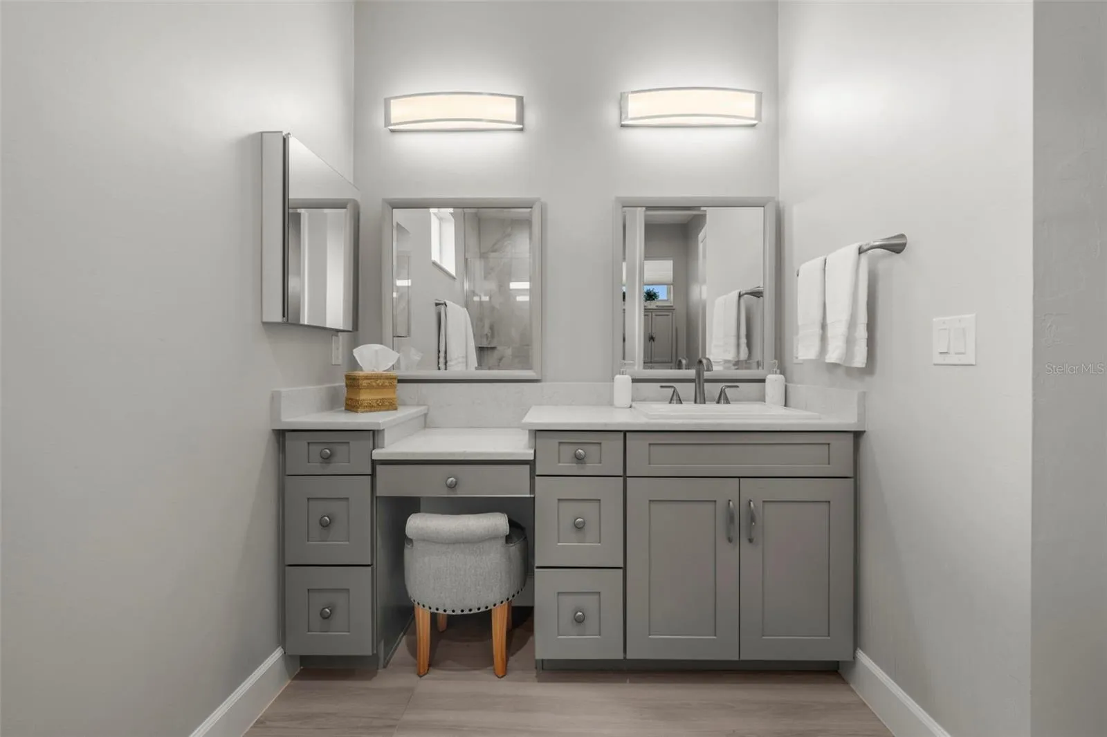 Custom mirrors and lighting. A makeup tier, too. Yes, the quartz and solid wood continues.
