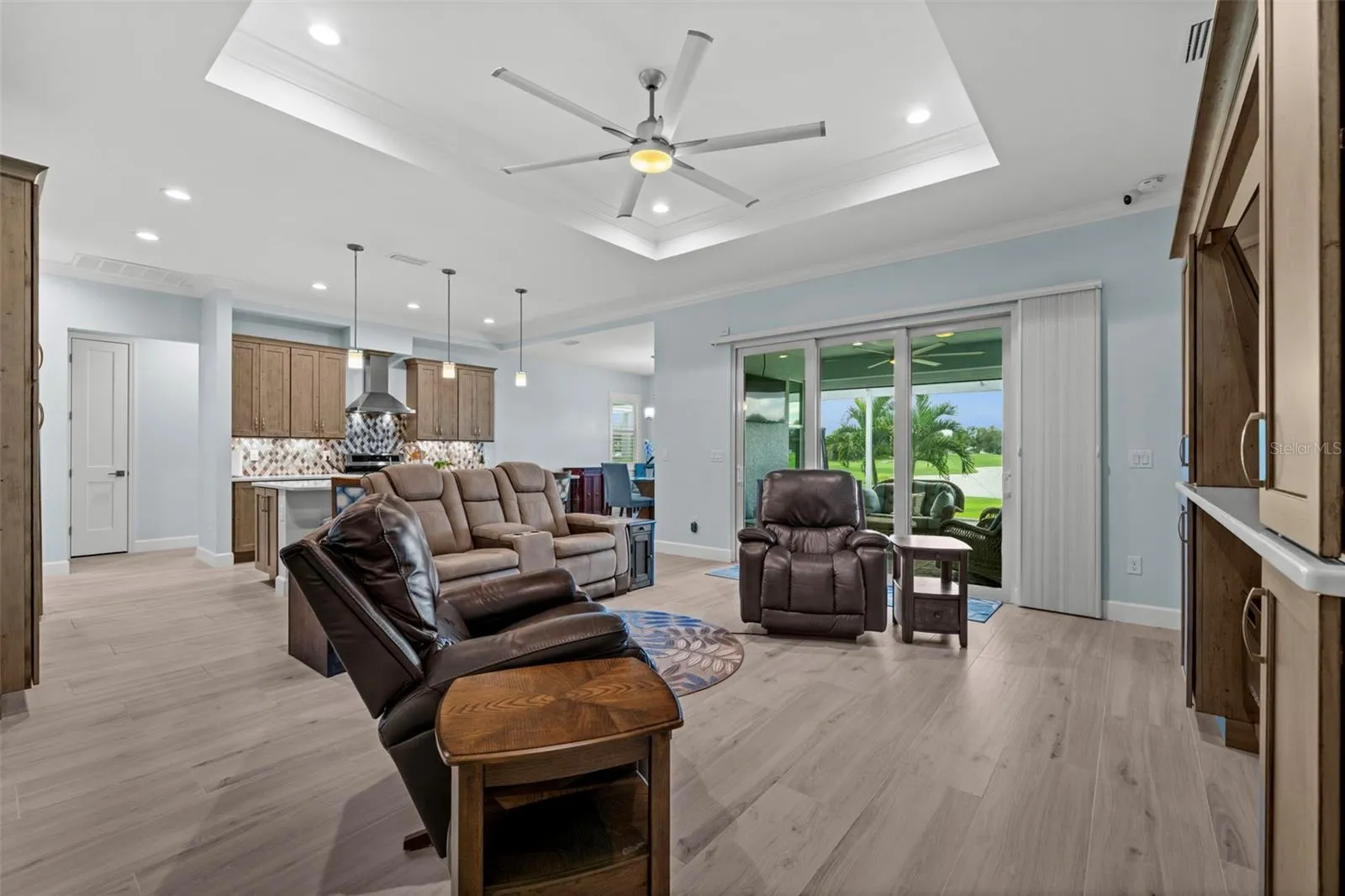 Note the built-in entertainment center, complete with a fireplace, matches to the solid wood kitchen cabinetry with quartz shelving.