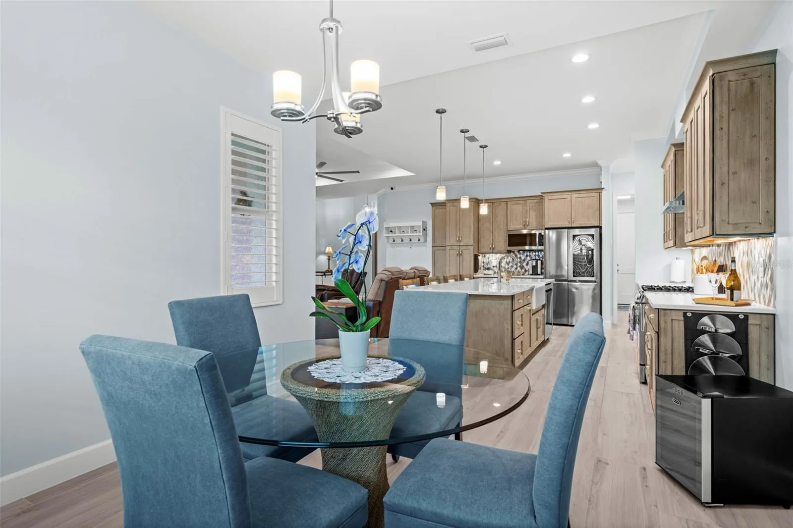 A dining area with plantation shutters and tranquil window views.