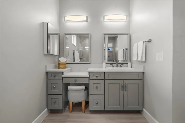Custom mirrors and lighting. A makeup tier, too. Yes, the quartz and solid wood continues.