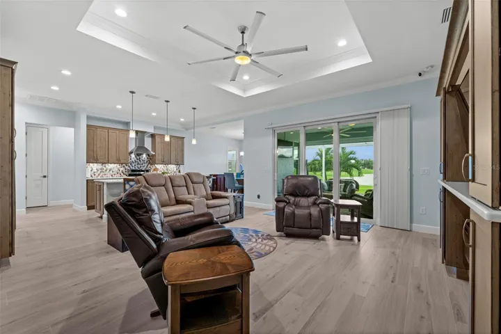 Note the built-in entertainment center, complete with a fireplace, matches to the solid wood kitchen cabinetry with quartz shelving.