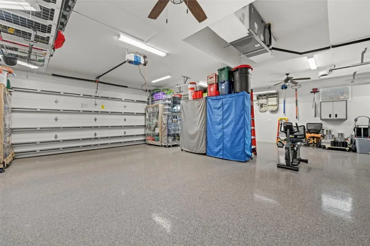 Two 8' garage doors with added insulation. There's a mini-split AC. And; notice the shining 5 coated floor.