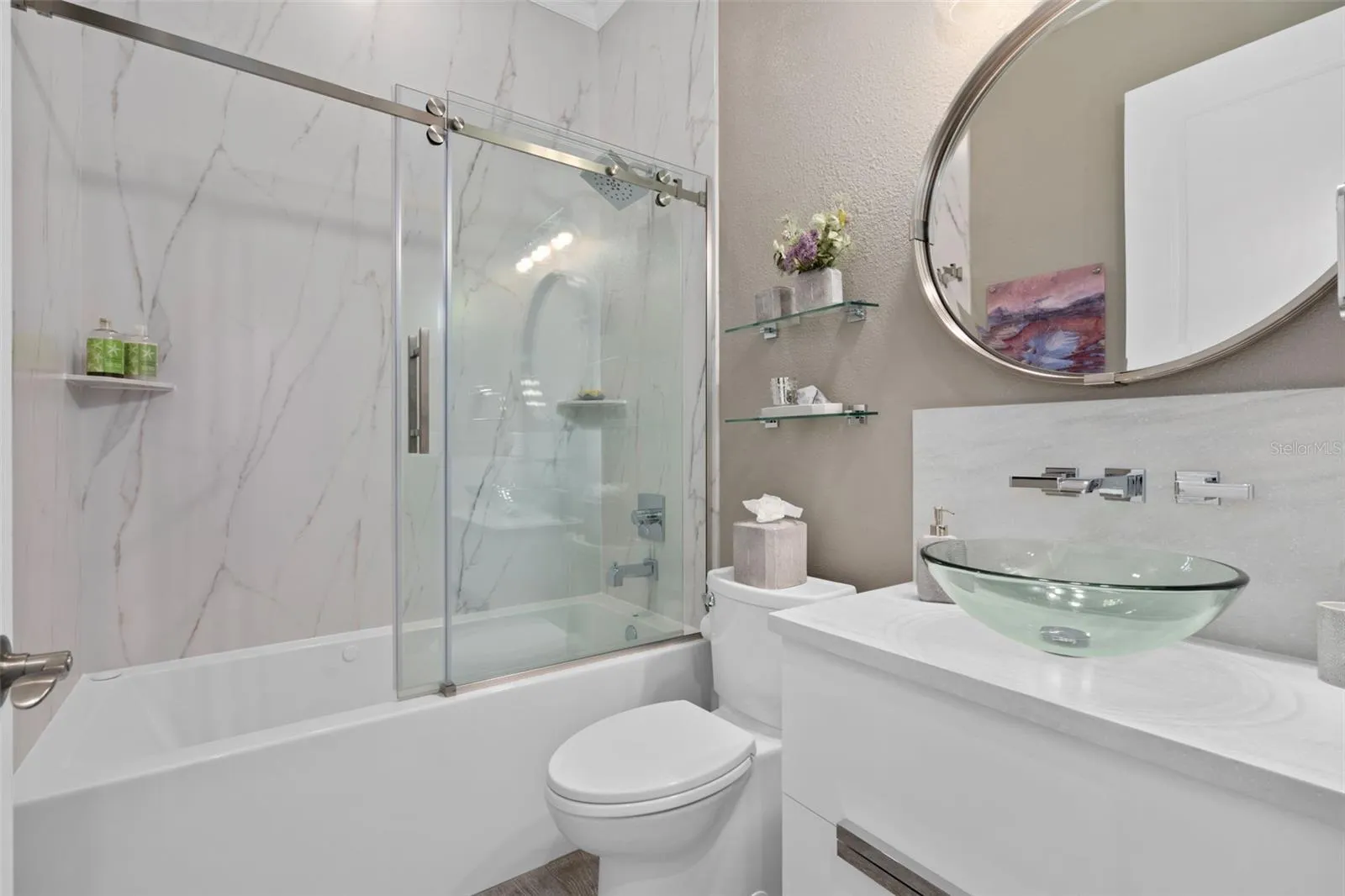 The Remodeled bathroom 3 is adjacent to Bedroom 3. The jetted tub also has bubblers in the base and is longer than a typical tub for your comfort. A stunning vanity, vessel sink and accessories adds the finishing touches.