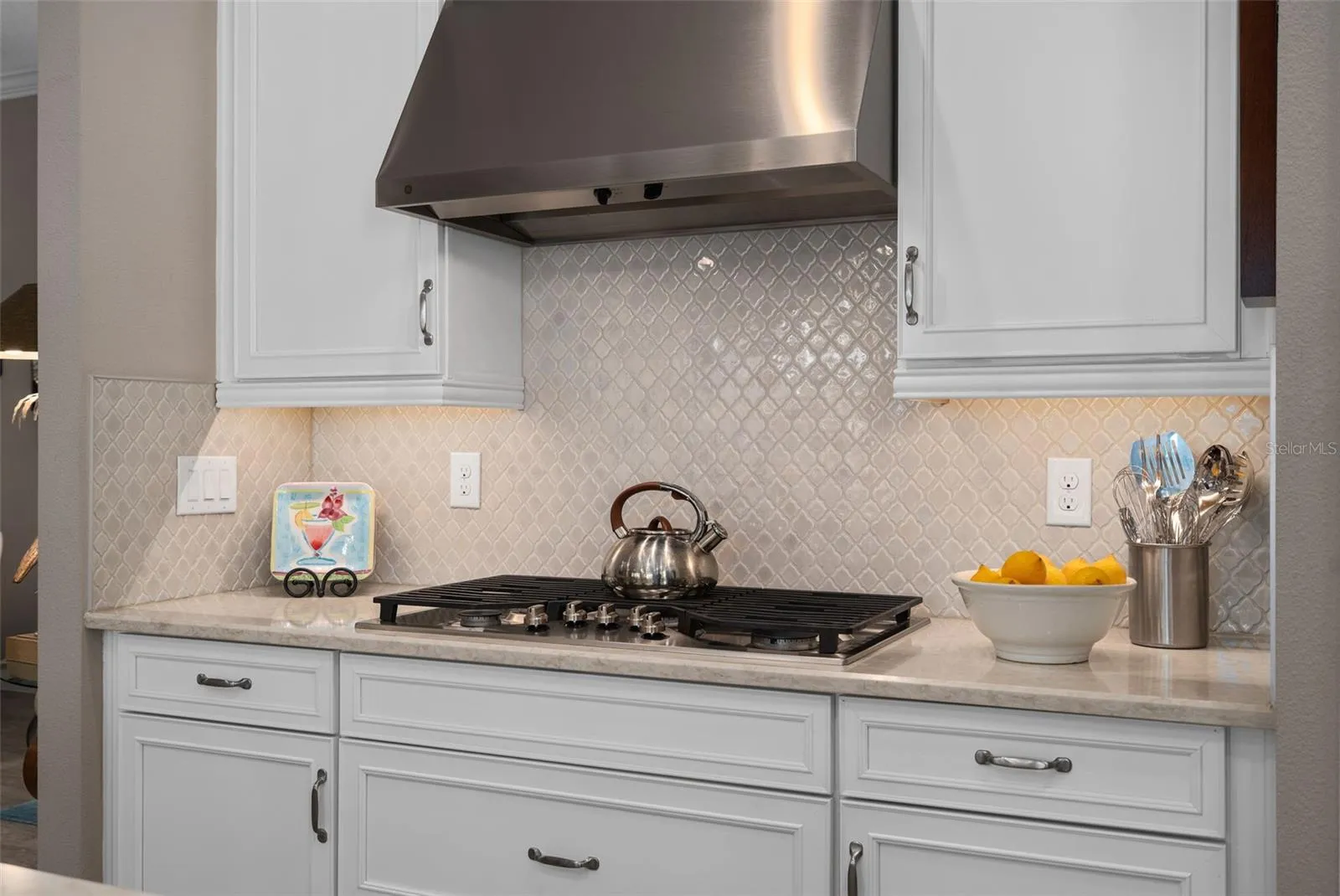 Built-in 5 burner cooktop with an outside vented hood fan.
