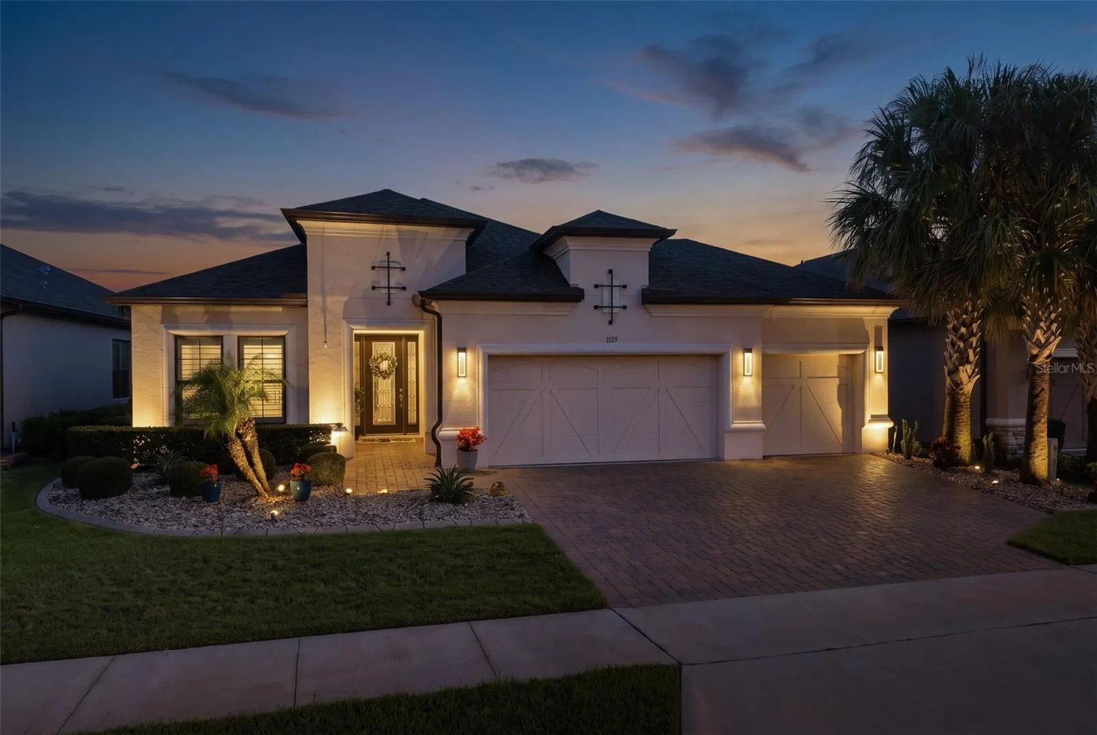 Beautiful curb appeal is accentuated with landscape lighting.