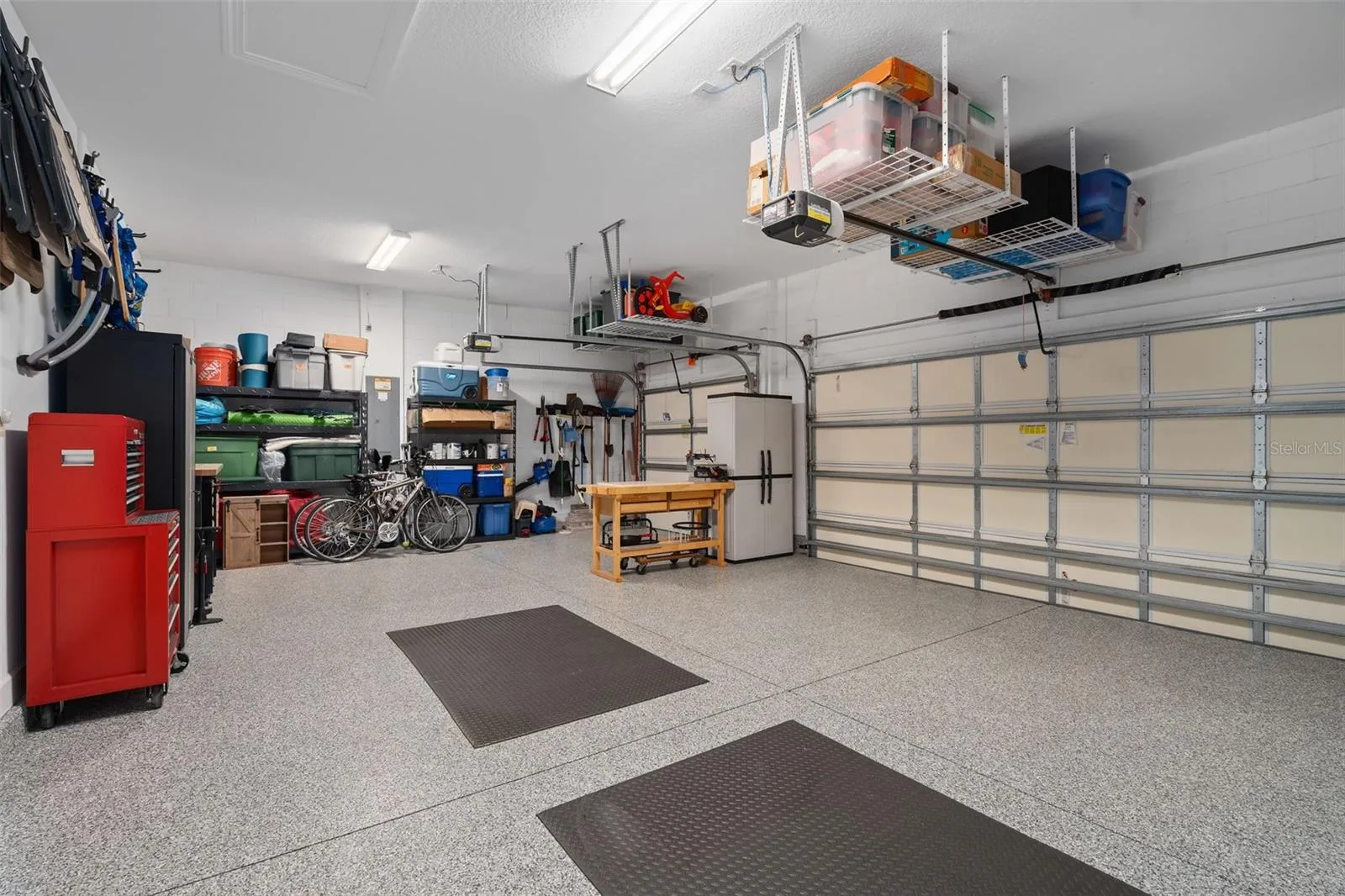 This full 3 car garage with a "Shark Coating" floor, Insulated garage doors and ceiling storage.