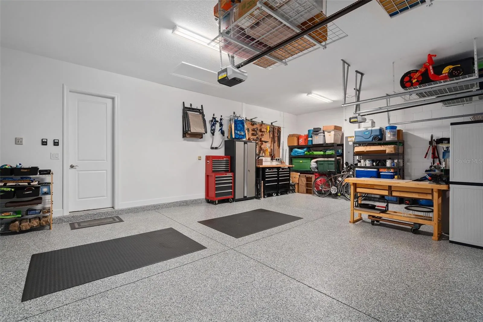 This full 3 car garage with a "Shark Coating" floor, Insulated garage doors and ceiling storage.