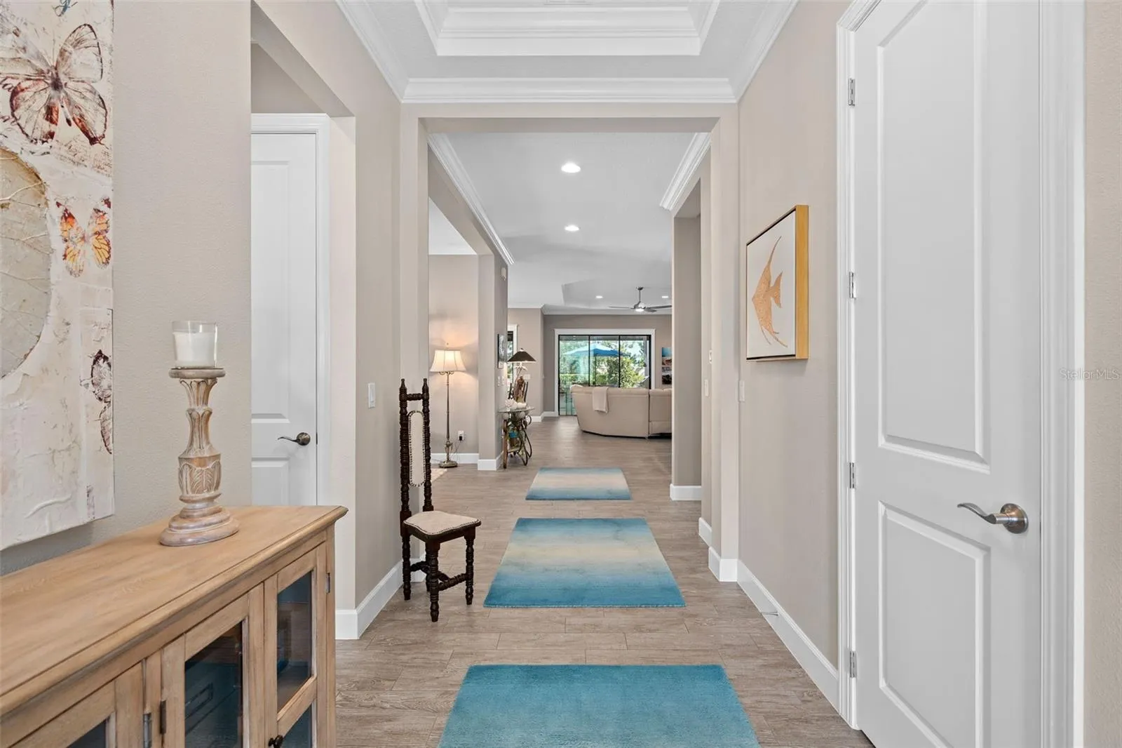 Upon entry you will be greeted by a see through floor plan offering 10' ceilings with tray's and crown molding.