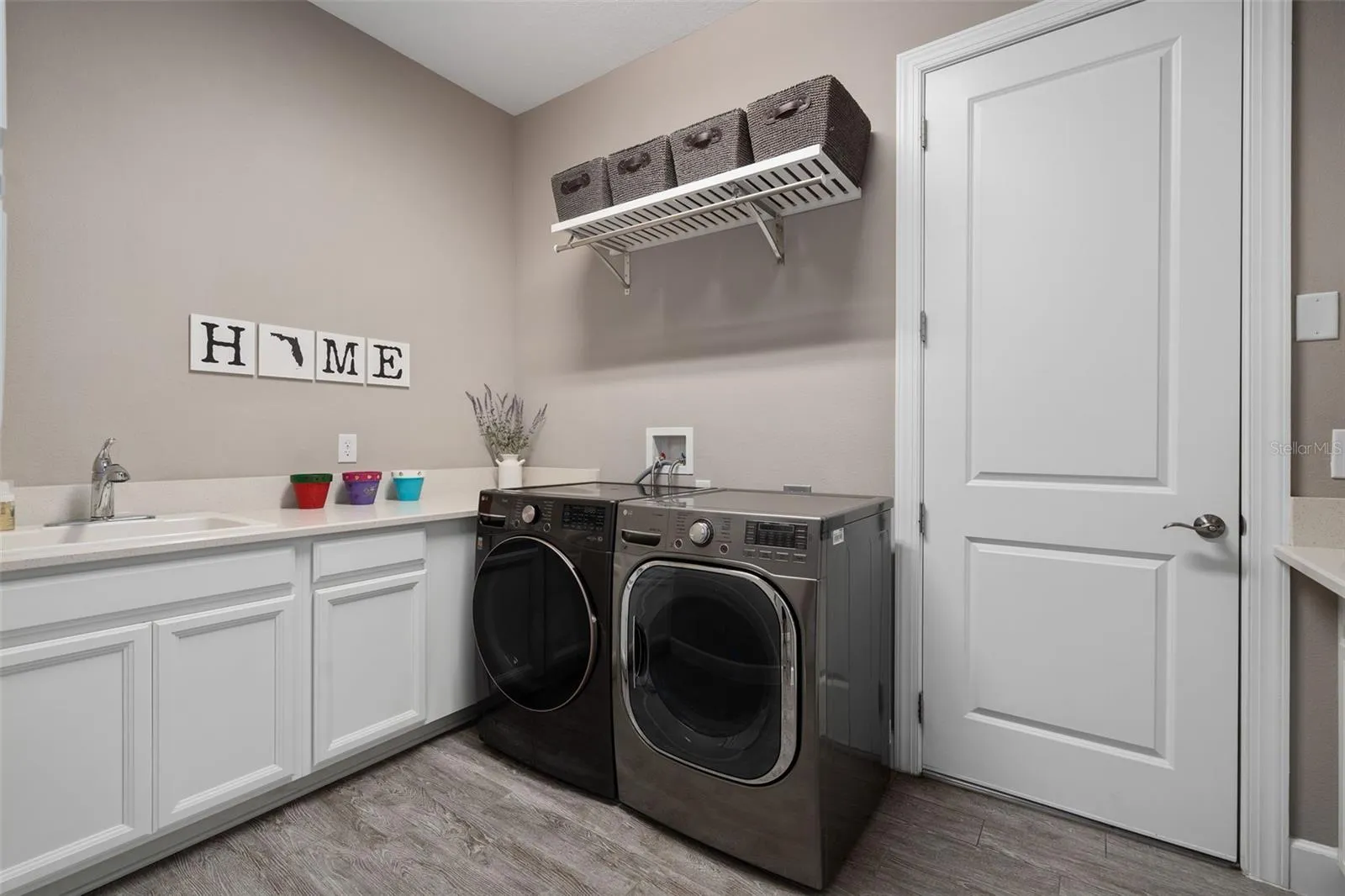 The laundry room has a sink and a drop area for your convenience.