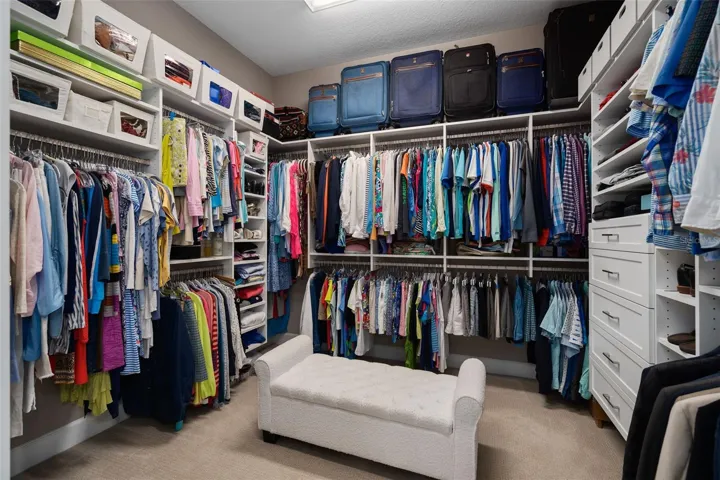 Primary Suite custom organized closet.