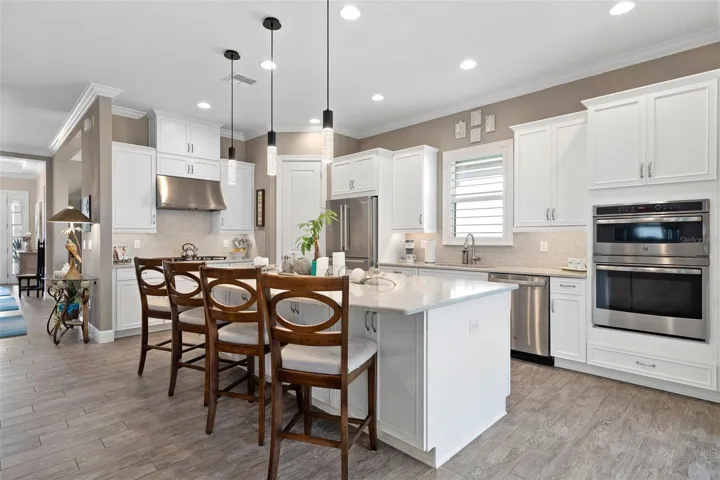 This Lazio model features the gourmet Kitchen option with an upgraded built-in cooktop, microwave and oven. The Quartz Countertops, upgraded cabinetry with pull-out shelves and front facing island cabinets offer ample storage.