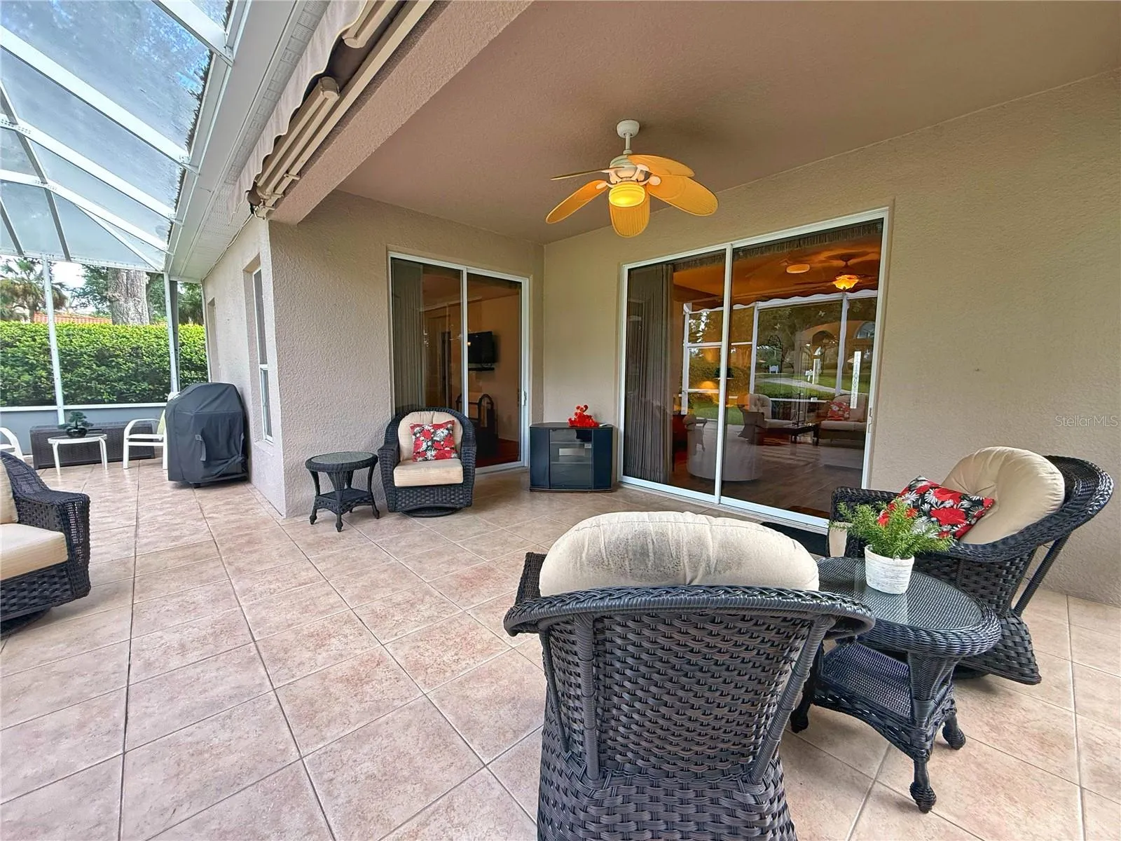 Additional view of the rear covered and screened in lanai with ceramic tile flooring