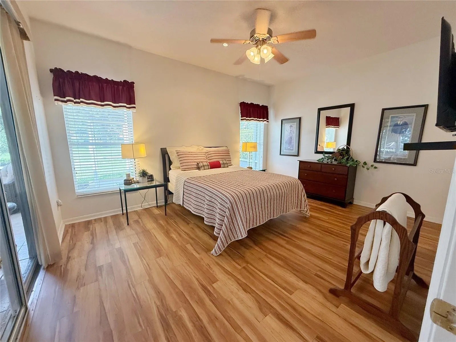 Additional Primary bedroom with sliding glass doors onto the lanai and a golf course view from every window, laminate flooring, en suite bathroom, walk in closet