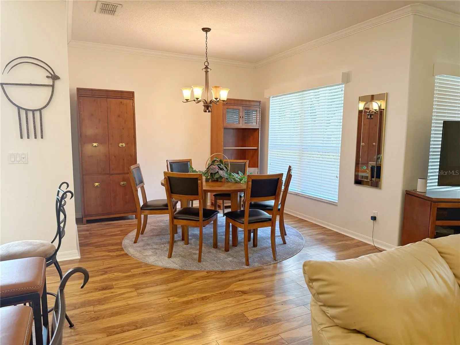 Additional Dining room view with view of golf course through the window, crown molding, laminate flooring