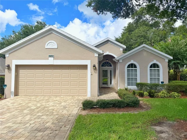 Front Exterior with Paver driveway, glass/screen storm door, Eyched glass front Entry door, gutters