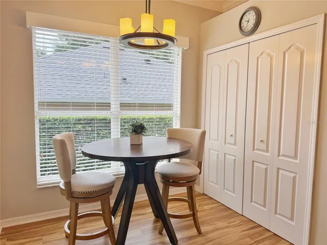 Dinette inside Kitchen with pantry, laminate flooring, crown molding, updated fixtures