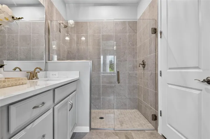 Frameless glass enclosure, seamless transition from floor to shower and turn-on valve to allow water to warm up before stepping in