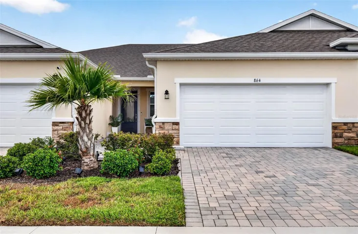 Front elevation with stone accent and paver driveway