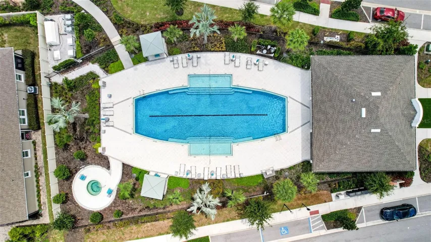 Community Pool surrounded by lush landscaping