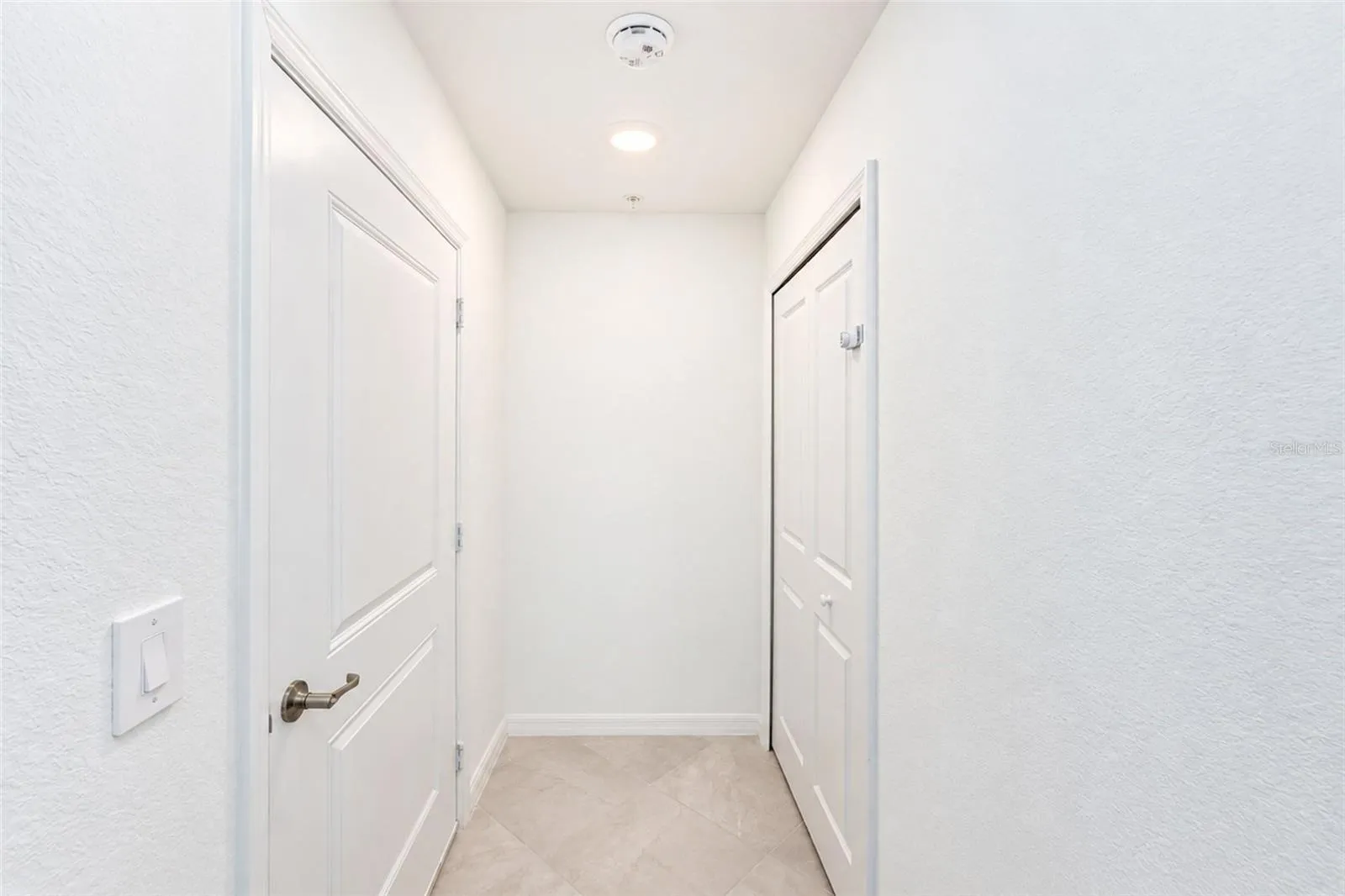 Lower hallway off the garage with Lg Closet