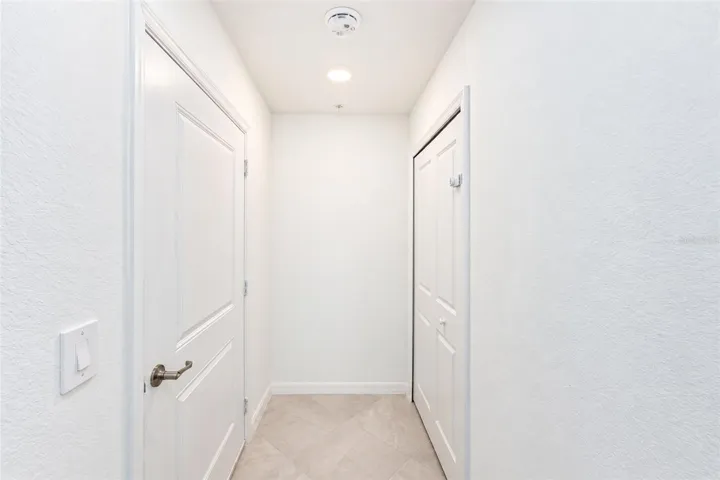 Lower hallway off the garage with Lg Closet
