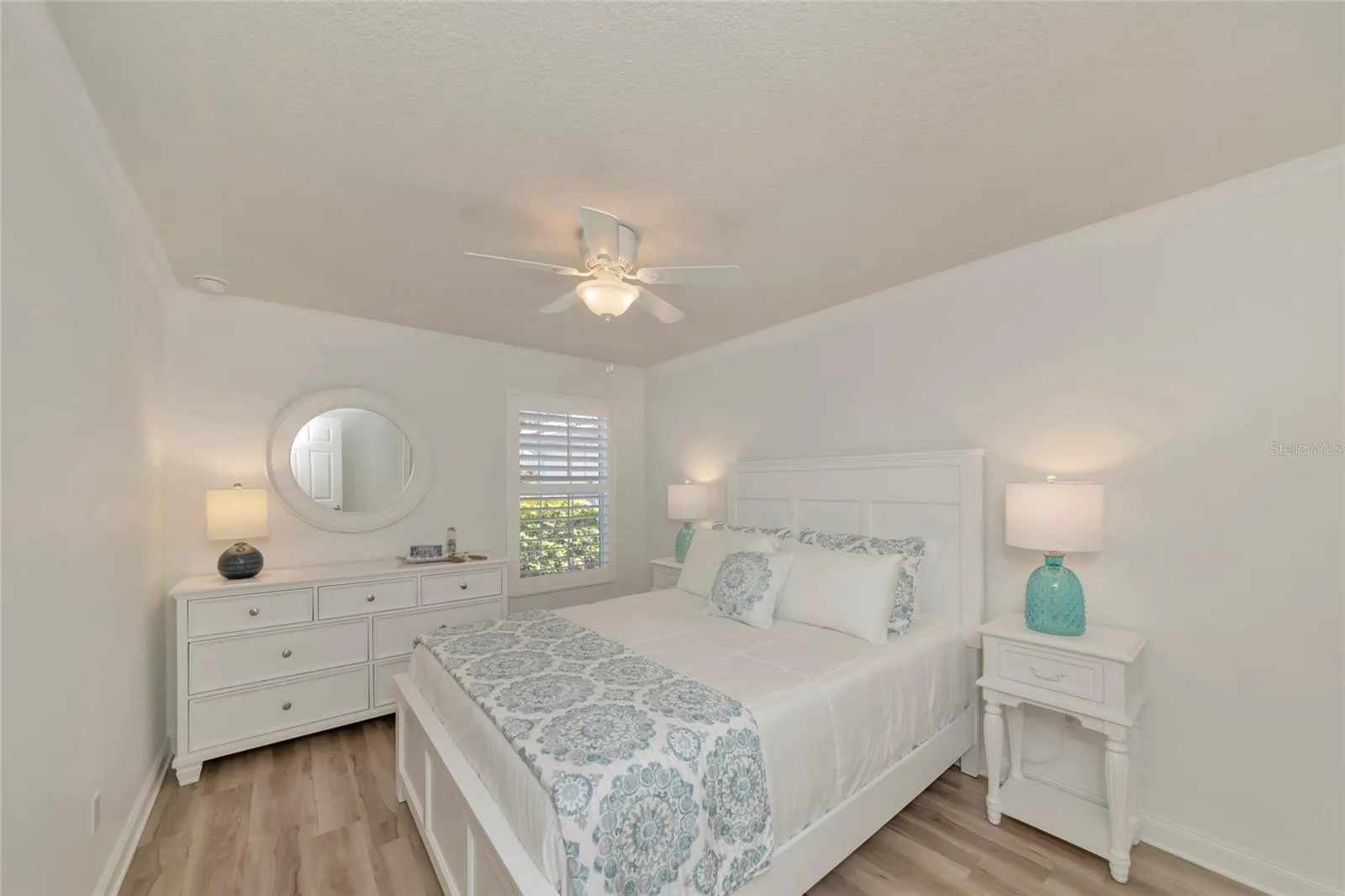 Front bedroom #2 w/ crown molding, wide plank floor, & walk-in closet.