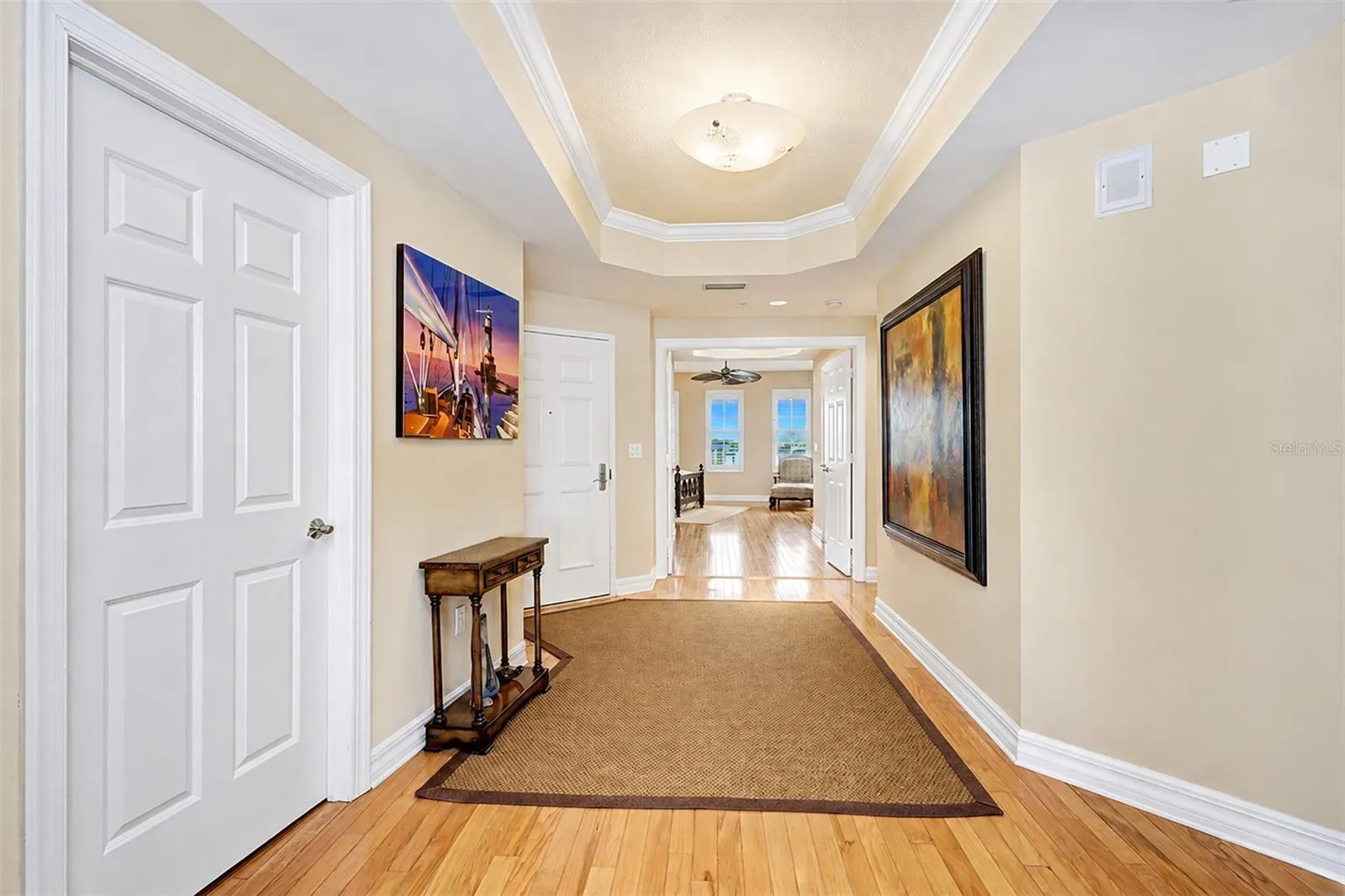 . Hallway - Looking out From Living Room Area .. Laundry Room to Left - Entrance Door on Far Left.. Main Guest Suite Thru Double Parlor Doors.. NOTE: All Interior Doors are Solid Core..