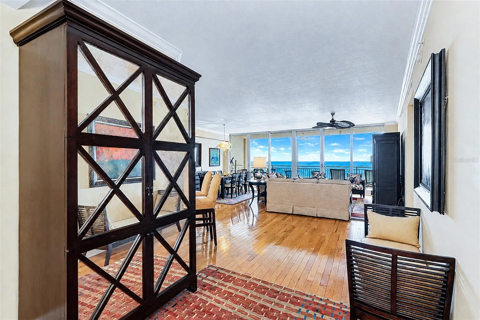... Entrance to Residence 404... Inviting Wood Floors, High Ceilings and a Wall of Waterfront Floor To Ceiling Impact Sliders That Seem to Allow the Long Range Aqua Blue Water Views to Drench the Great Room  Grab Your Attention.