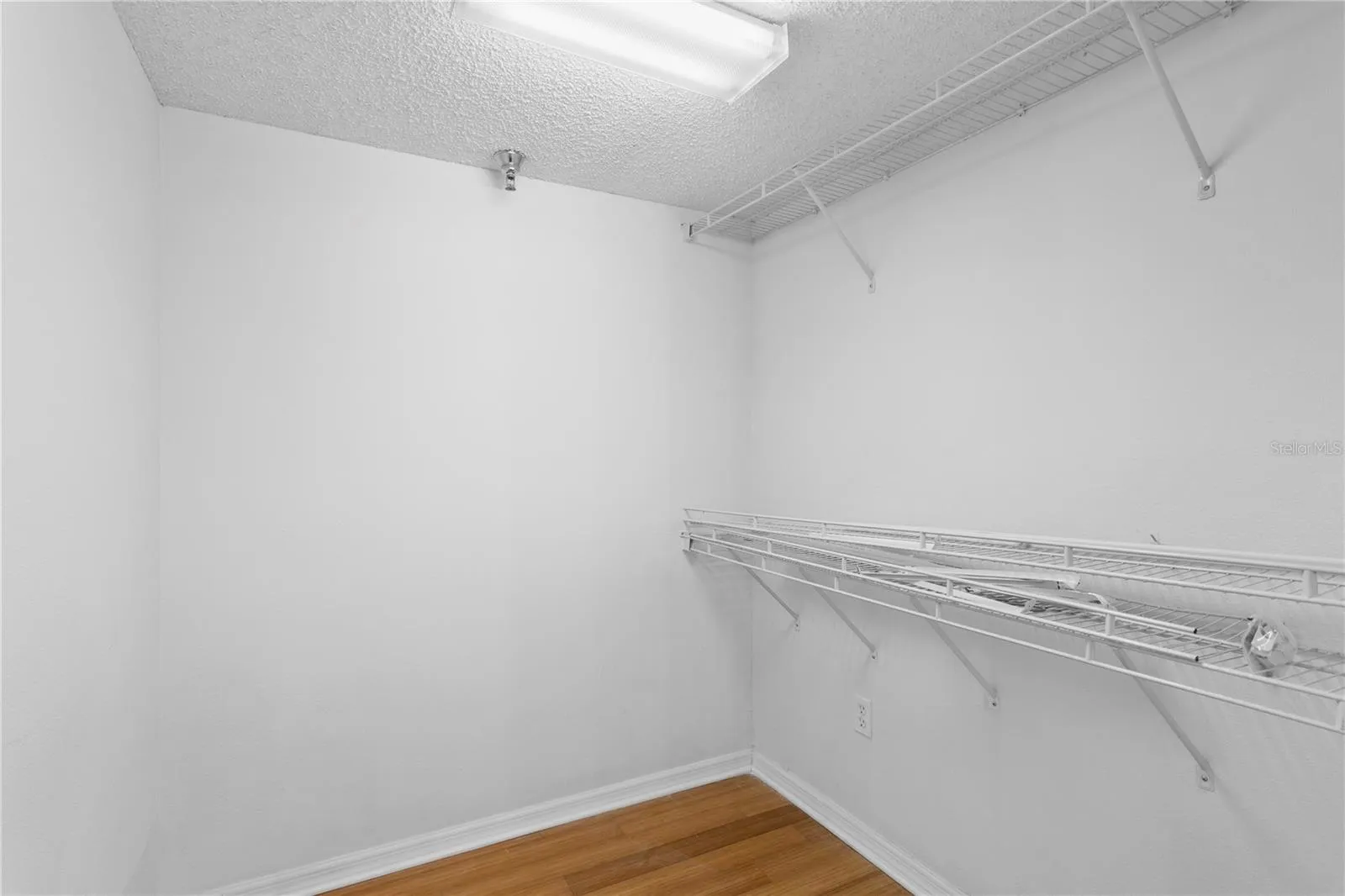 Walk-in closet designed to maximize storage and functionality.