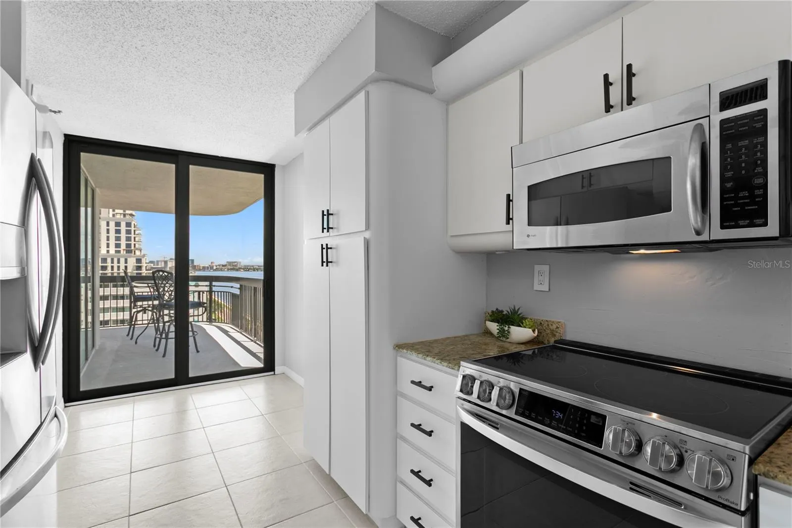 The kitchen has direct balcony access—perfect for effortless al fresco dining.