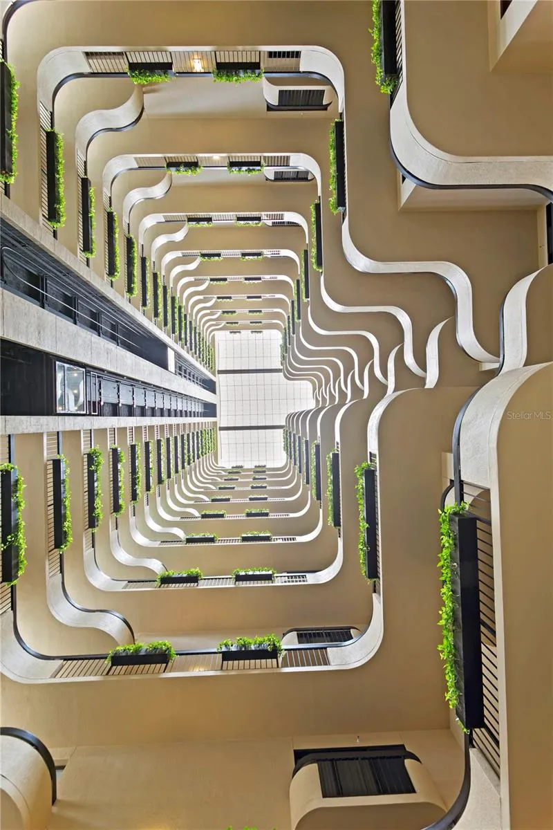 An upward view reveals layered levels, and live greenery bathed in natural light.