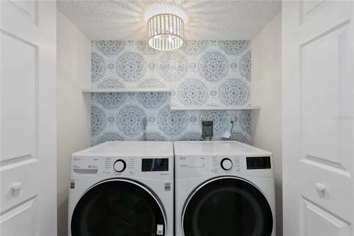 In-residence laundry has been thoughtfully enhanced with a full-size washer and dryer plus additionalwell-organized storage.
