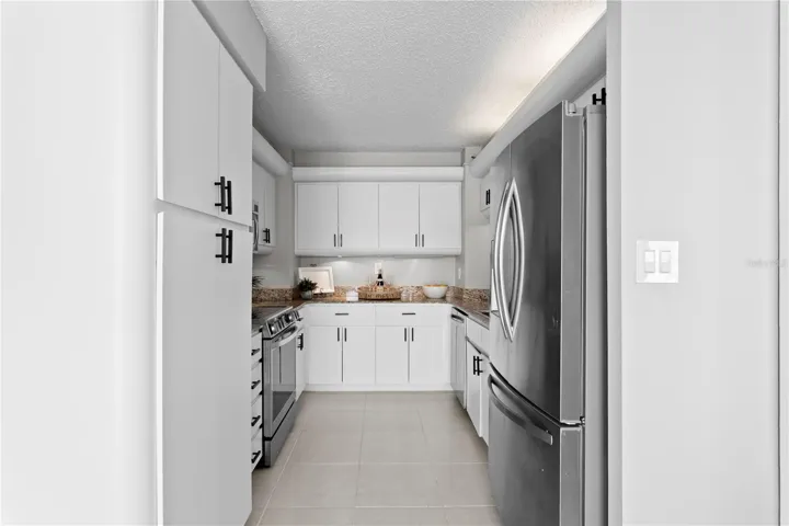 The well-appointed kitchen offers abundant cabinetry, and stainless steel appliances.