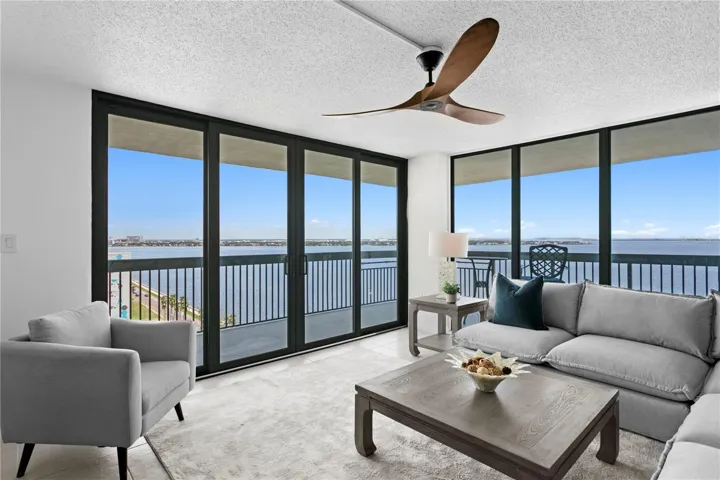 Floor-to-ceiling windows create a dramatic backdrop of Bayshore Boulevard and the sparkling waters beyond.