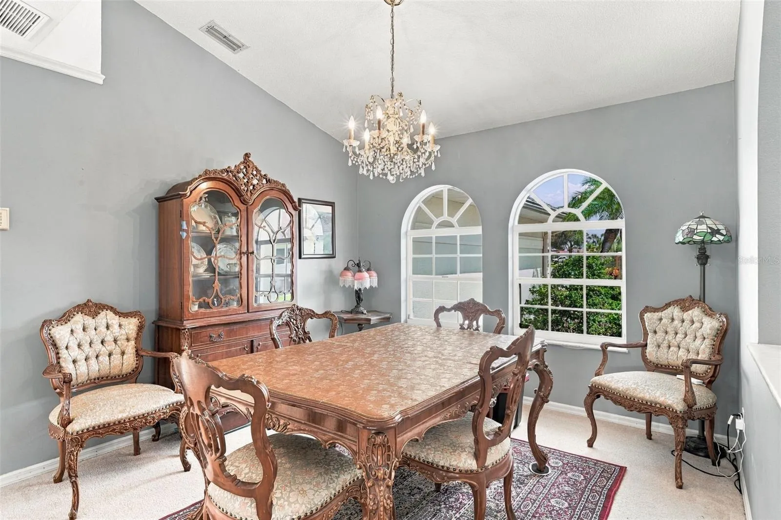 Formal Dining Room with Arched Windows, and Elegant Chandelier