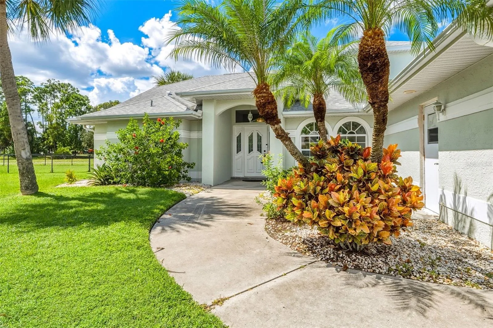 Beautiful Curb Appeal Surrounded by Lush Tropical Landscaping