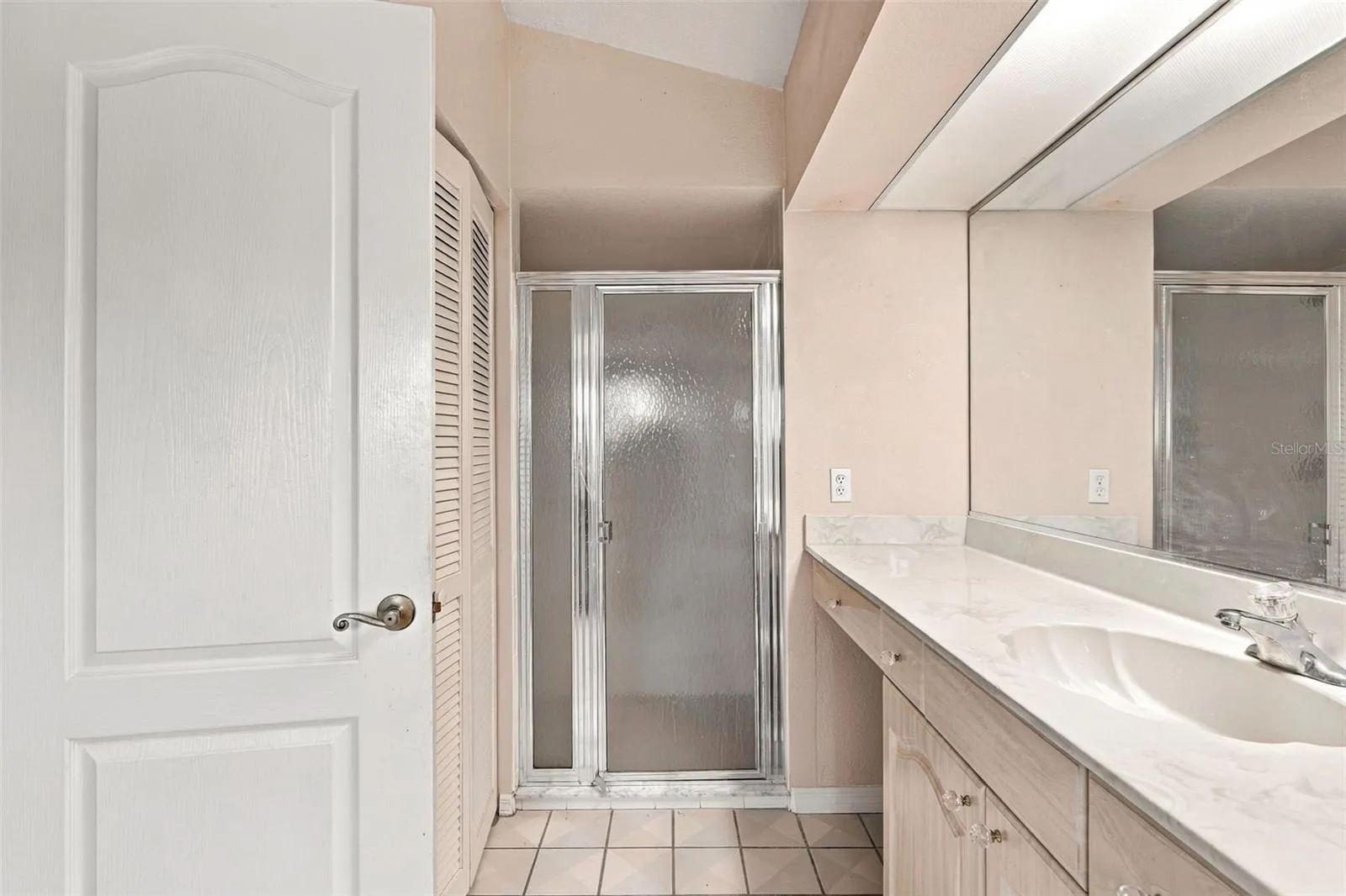 Glass Enclosed Walk-In Shower, Closet and Ample Vanity Space in Master Bathroom