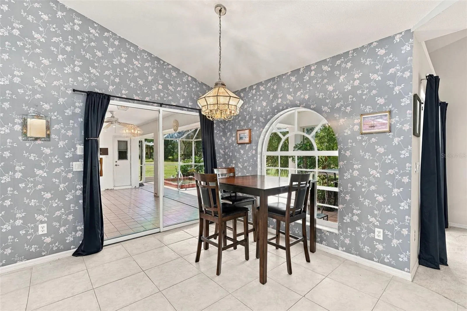 Dining Area with Arched Window and Lanai Access