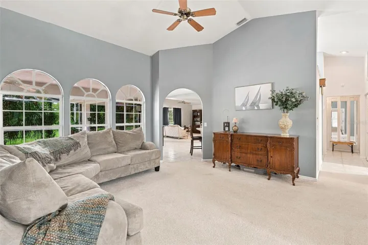 Inviting Living Space with an Open Layout, High Ceiling and Arched Windows