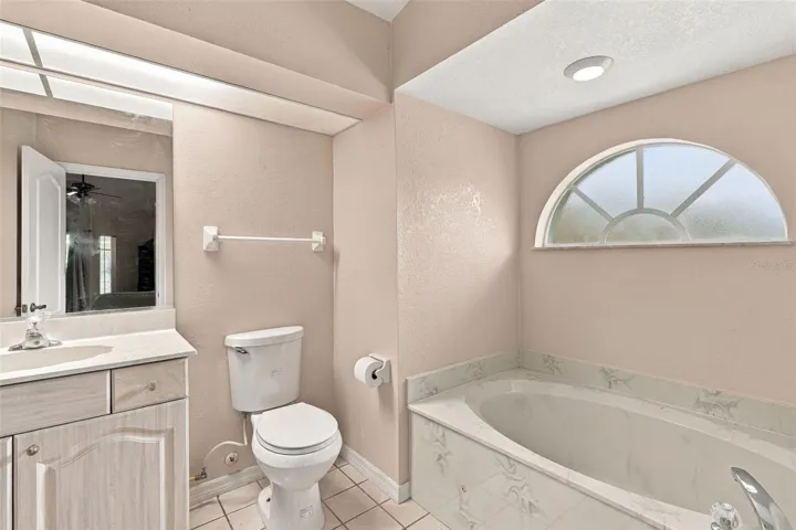 Primary Bathroom with Soaking Tub and Half-Round Window for plenty of Natural Light