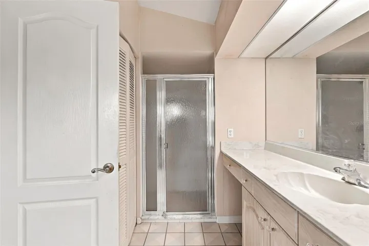 Glass Enclosed Walk-In Shower, Closet and Ample Vanity Space in Master Bathroom