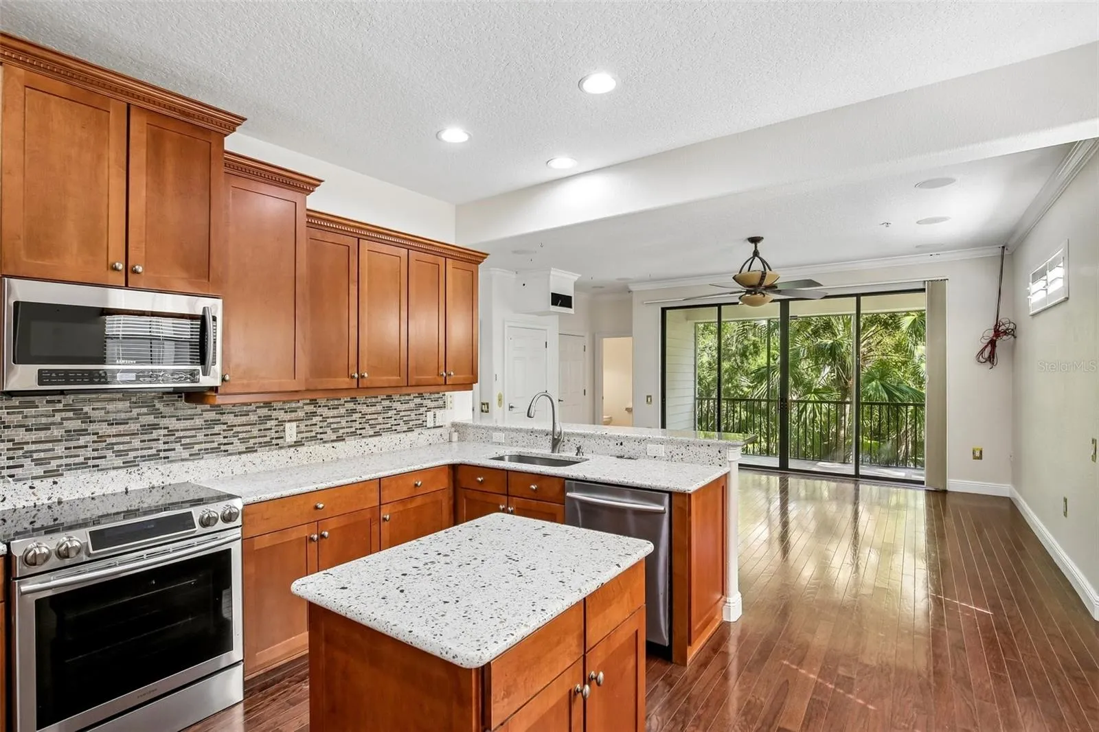From the kitchen on the 2nd floor looking toward the balcony and the flex room good for entertaining