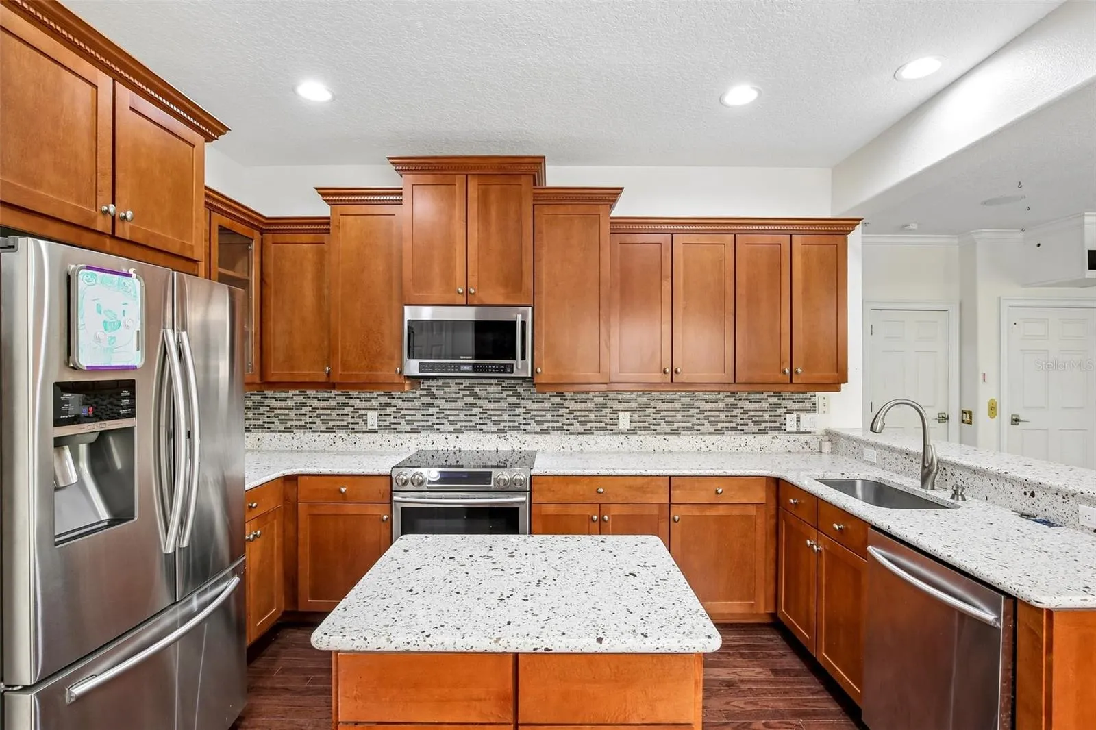The very useable kitchen on the 2nd floor with island in the middle and plenty of cabinet space