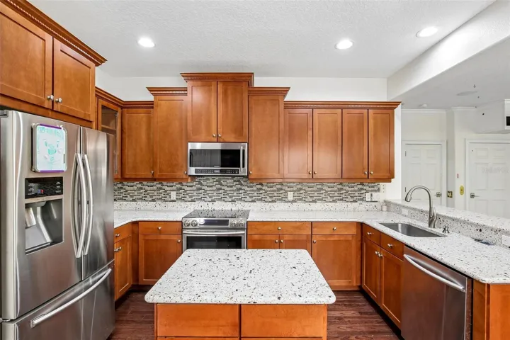 The very useable kitchen on the 2nd floor with island in the middle and plenty of cabinet space