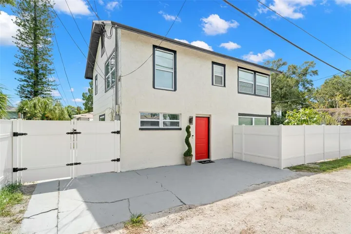 Private entrance to Unit B, a remodeled 1-bedroom residence offering additional rental-income and vinyl privacy fencing.
